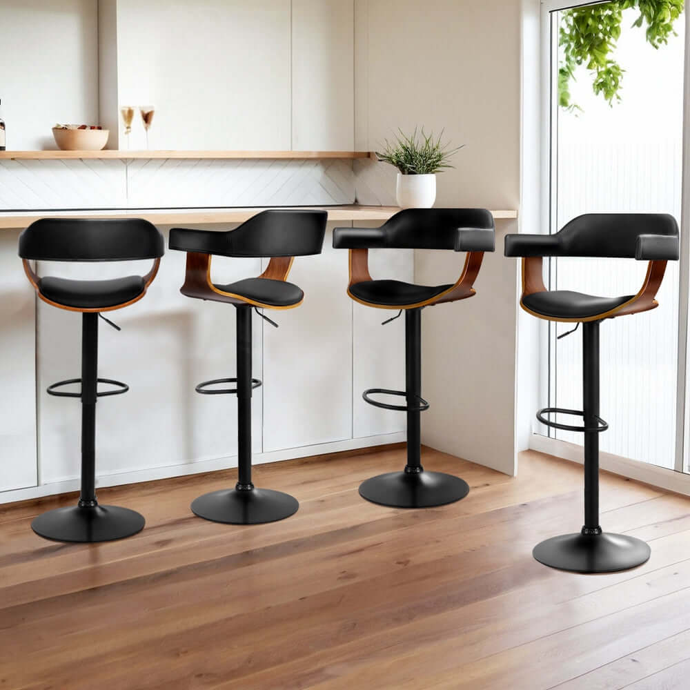 Four Artiss bar stools with gas lift, leather seats, and wooden accents in a modern kitchen setting.