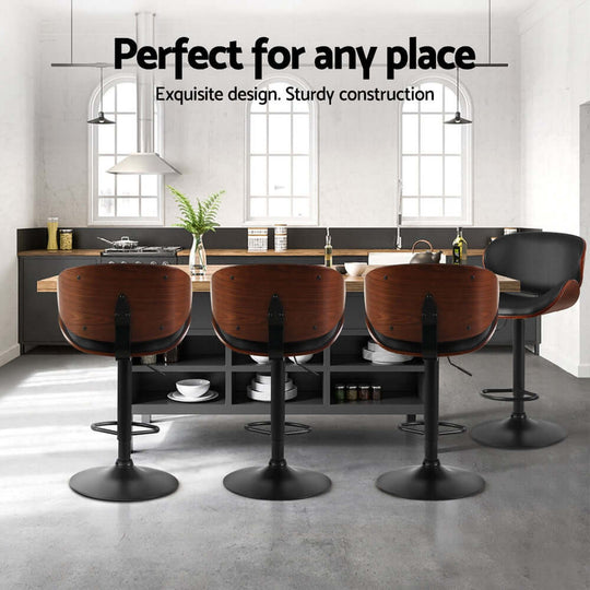 Artiss black leather bar stools with wood accents in modern kitchen setting, showcasing elegant design and sturdy construction.