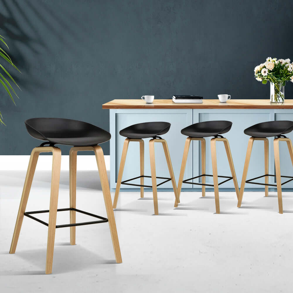 Elegant black and wooden bar stools in modern kitchen, perfect for affordable luxury dining.