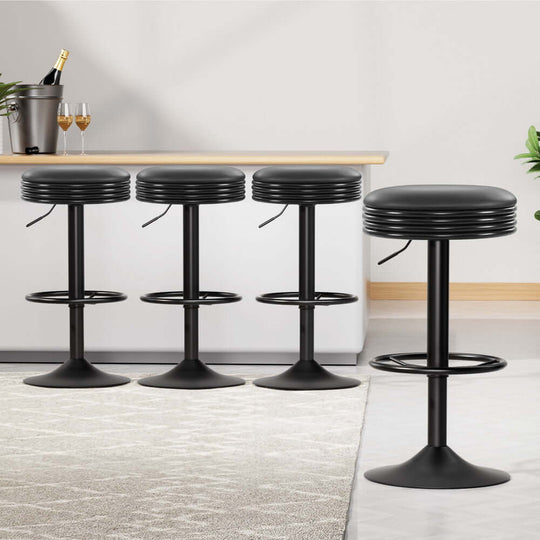 Set of four affordable black leather padded bar stools with chrome gas lift, perfect for modern decor.