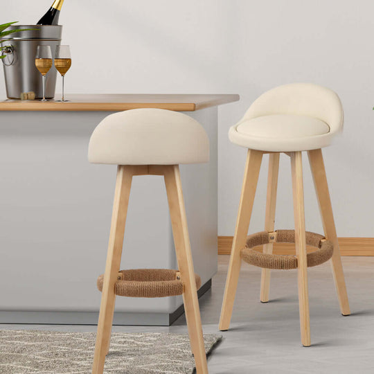 Affordable beige padded leather bar stools with wooden legs and unique hemp rope footrest for stylish seating.