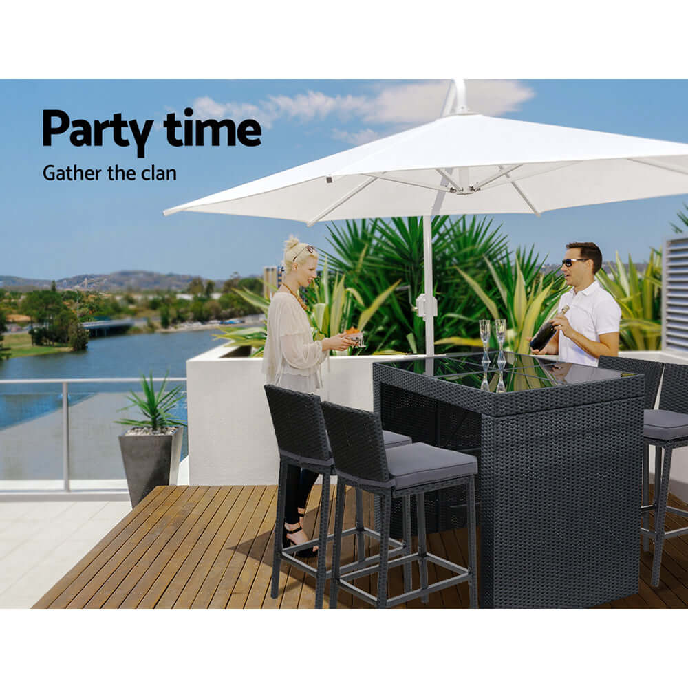 Gardeon outdoor bar set featuring stylish table and stools with umbrella for a chic summer party on a deck by the water.