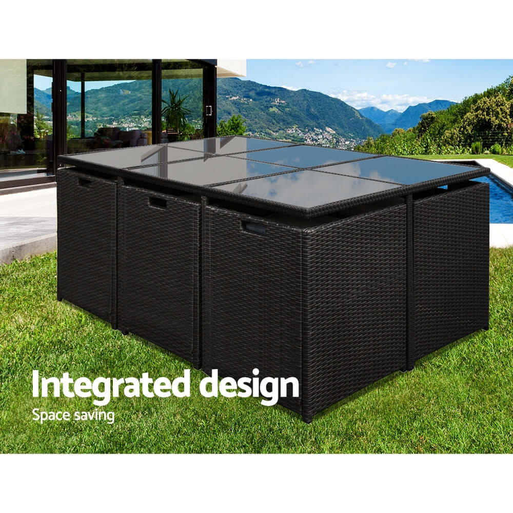 Gardeon outdoor dining set featuring integrated design for space saving, with a stylish black wicker finish and tempered glass top.