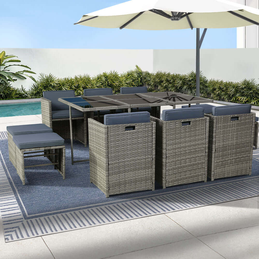 Gardeon 11-piece wicker outdoor dining set with table, chairs, and ottomans by poolside in grey finish.