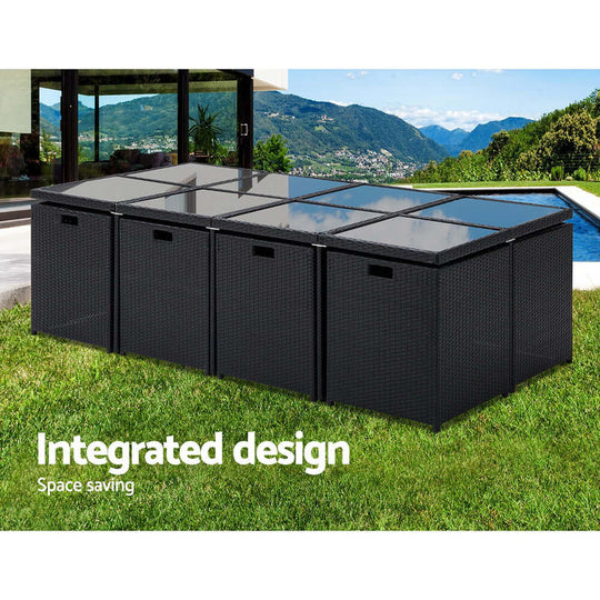 Gardeon outdoor dining set with integrated design, space-saving, modern wicker layout in a scenic garden setting.