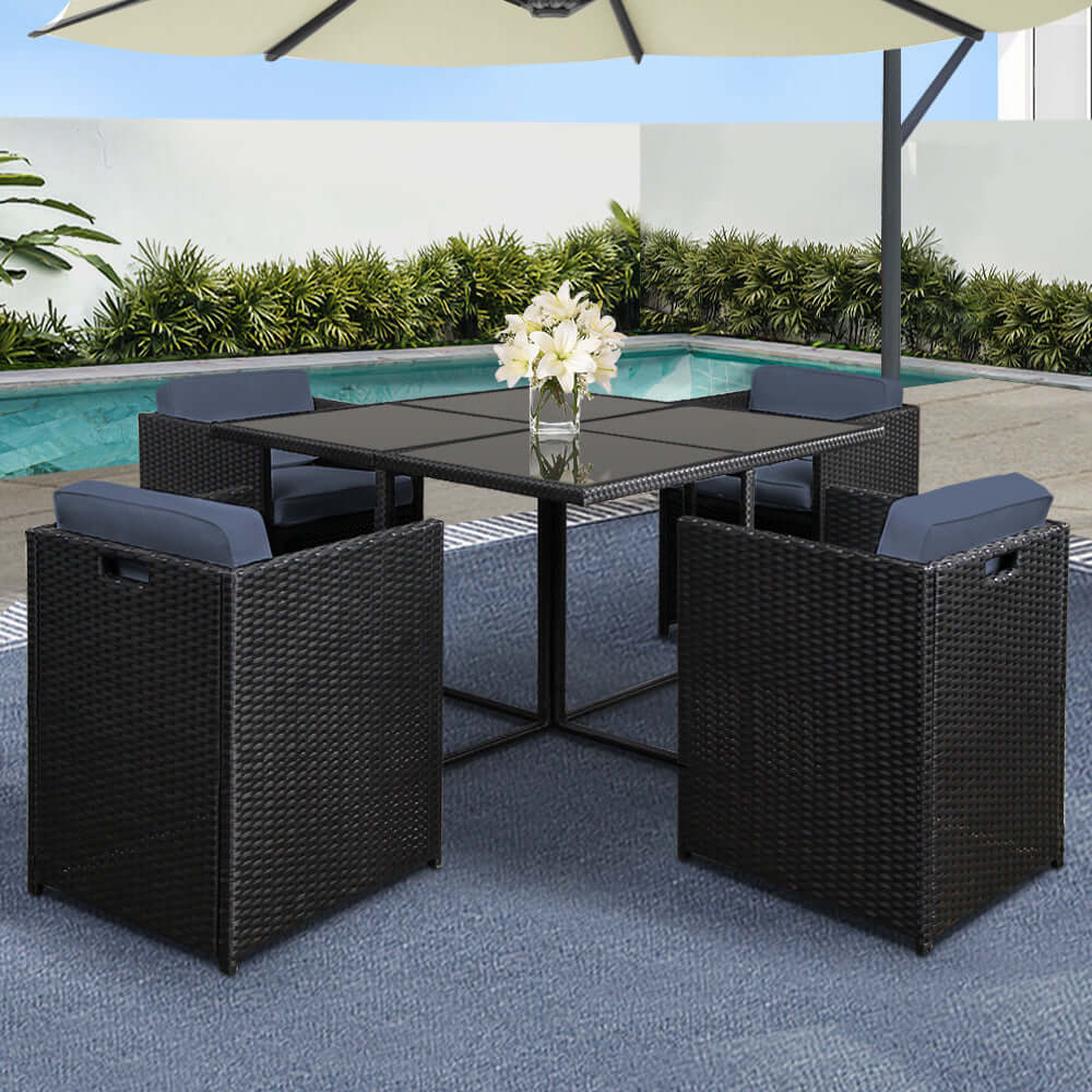 Gardeon 5-piece outdoor dining set with wicker chairs and glass table by poolside, stylish and affordable.