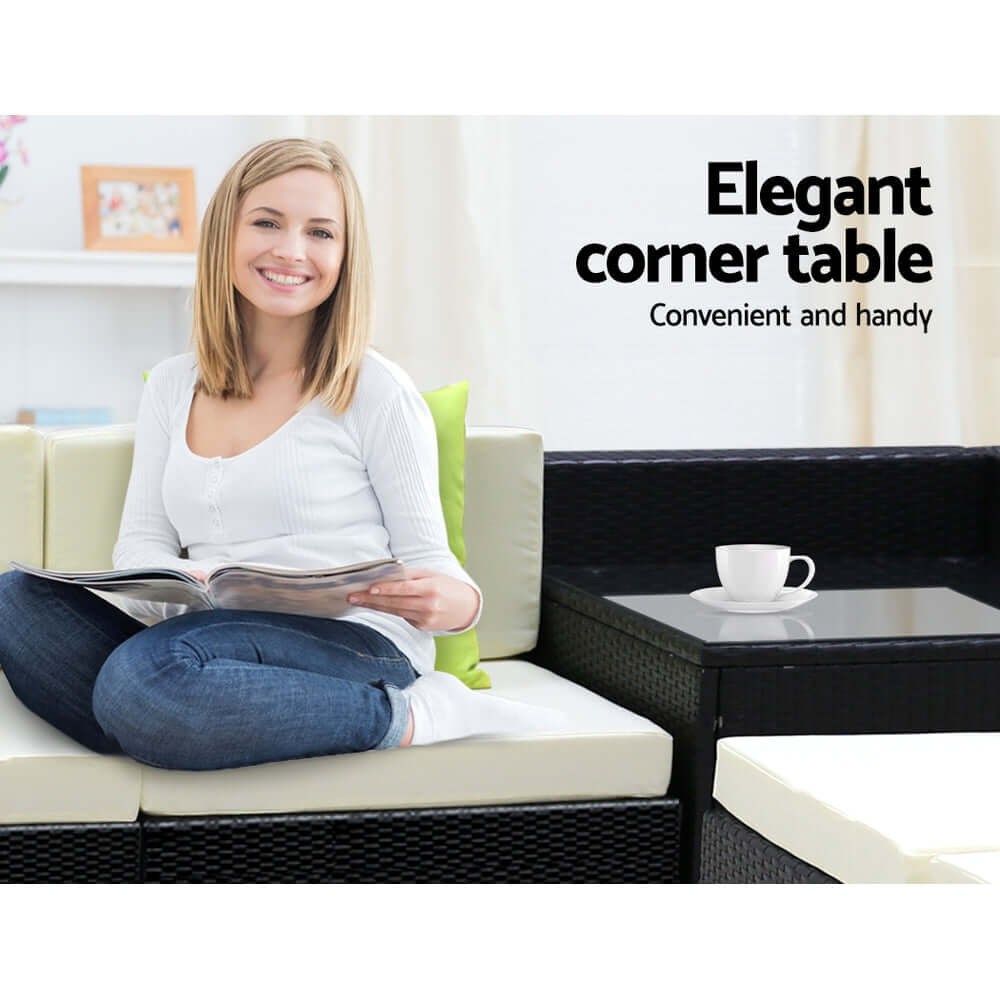 Woman reading on a stylish outdoor sofa set with an elegant corner table nearby, showcasing comfort and convenience.