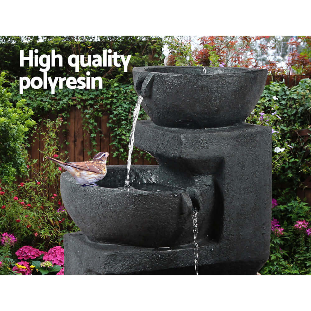 Gardeon Solar Water Fountain 3-Tier Bowl in garden, made of high quality polyresin, features water cascading for bird bathing.