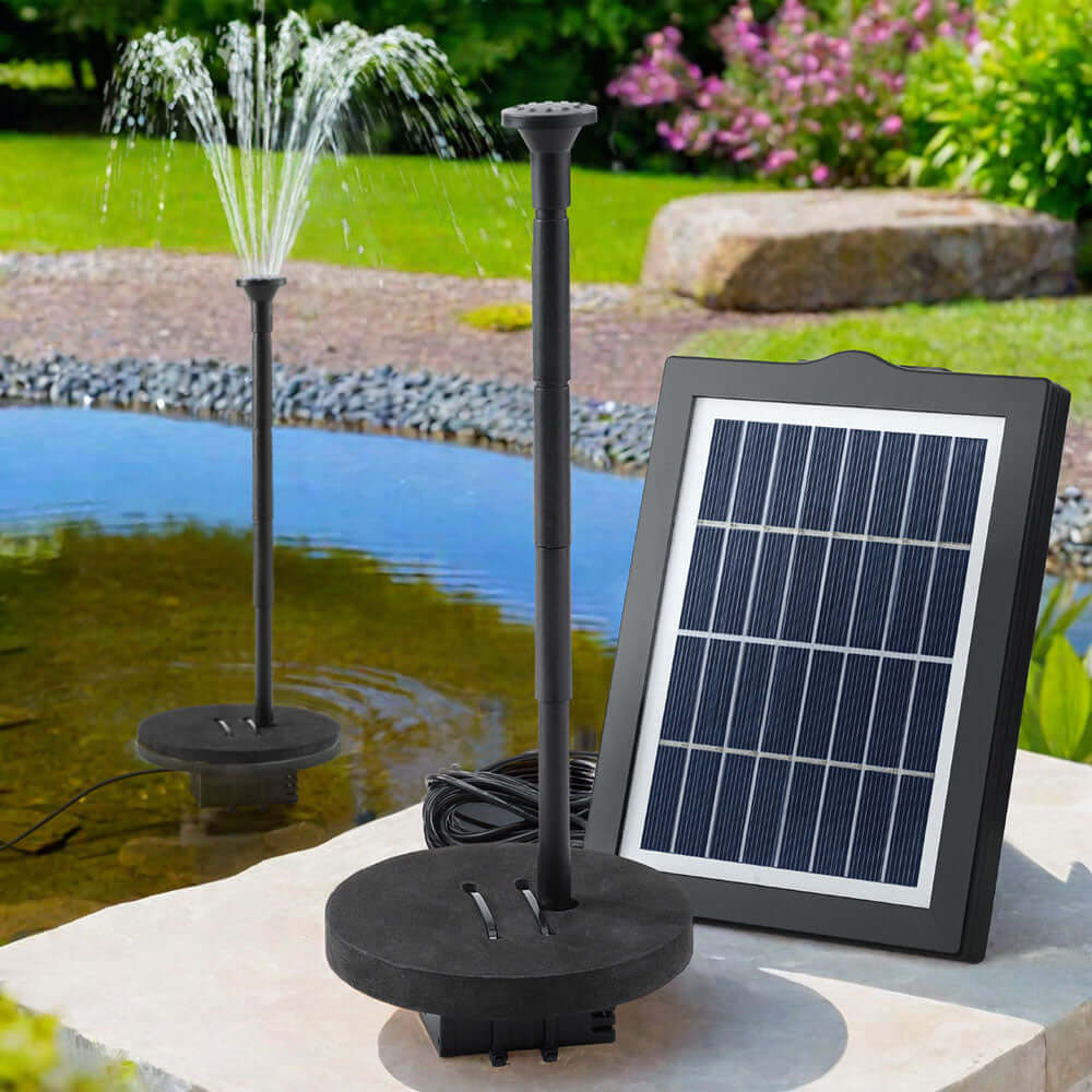 Gardeon solar pond pump with solar panel, creating a beautiful fountain in a garden water feature.