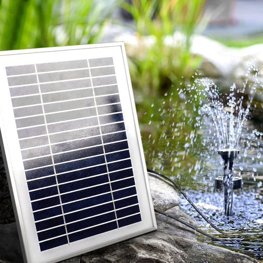 Solar panel for Gardeon pond pump with fountain spray in garden, affordable DIY water feature enhancing outdoor space.