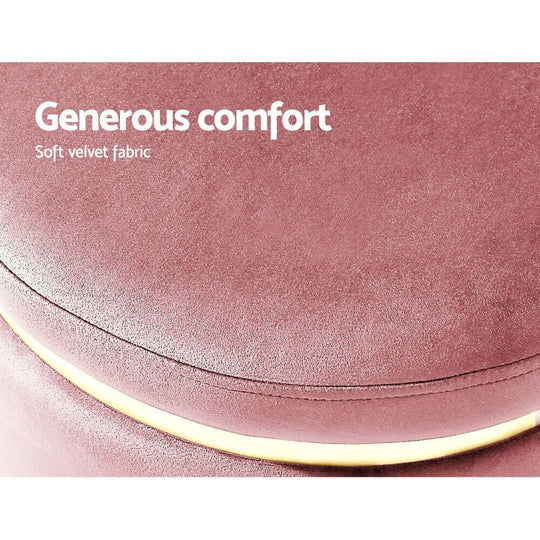 Close-up of round pink velvet footstool highlighting soft fabric and luxurious comfort.