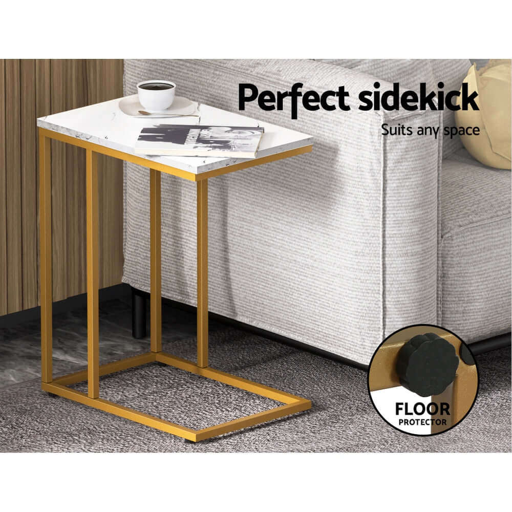 Modern marble effect side table with gold metal frame next to sofa, ideal for living room.