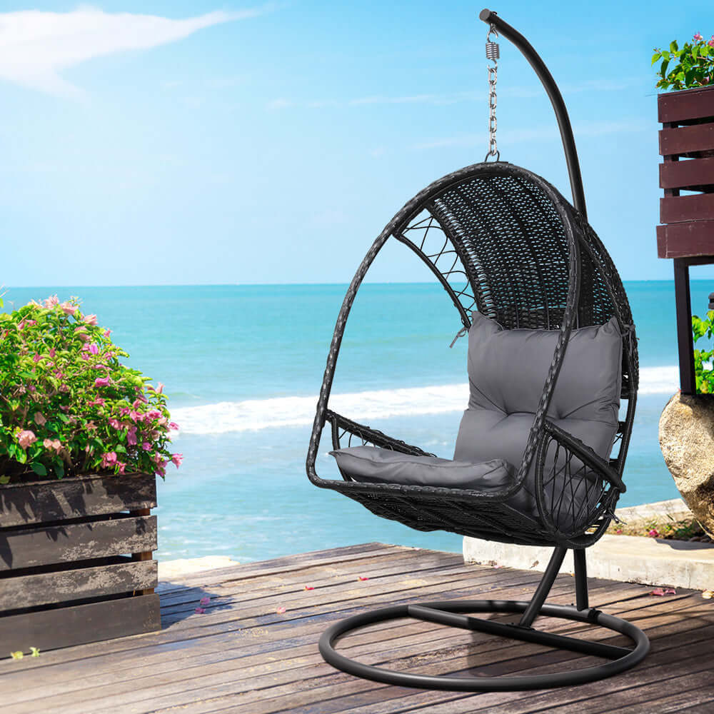 Gardeon outdoor egg swing chair in black wicker with gray cushions, perfect for affordable luxury relaxation.