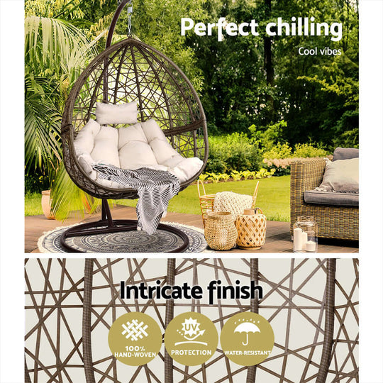 Gardeon outdoor egg swing chair with plush cushions, 100% hand-woven wicker finish for quality and comfort in a stylish garden setting.