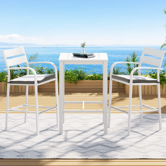 Gardeon outdoor bar set with two stools and table on patio, overlooking ocean view, perfect for affordable luxury dining.