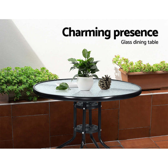 Charming glass dining table with plant, enhancing outdoor space aesthetics. Affordable and quality patio furniture.