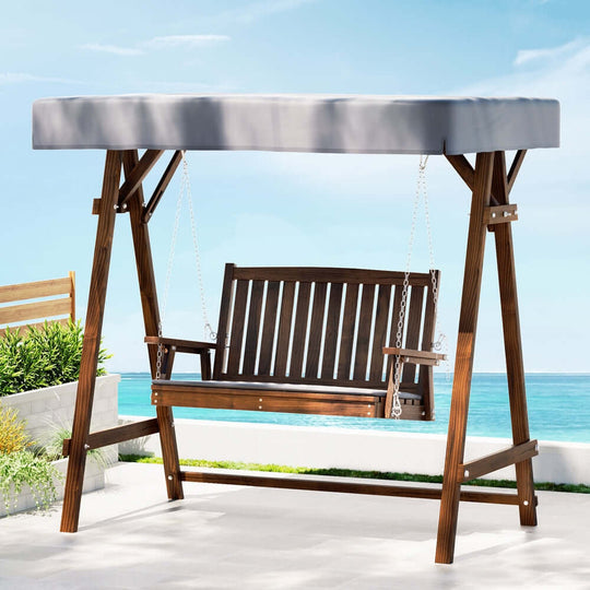 Gardeon outdoor wooden swing chair with canopy and cushion for two, perfect for relaxing in the garden.