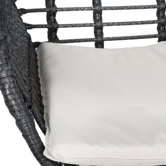 Comfortable grey wicker chair cushion for outdoor furniture, perfect for a stylish patio lounge setting.