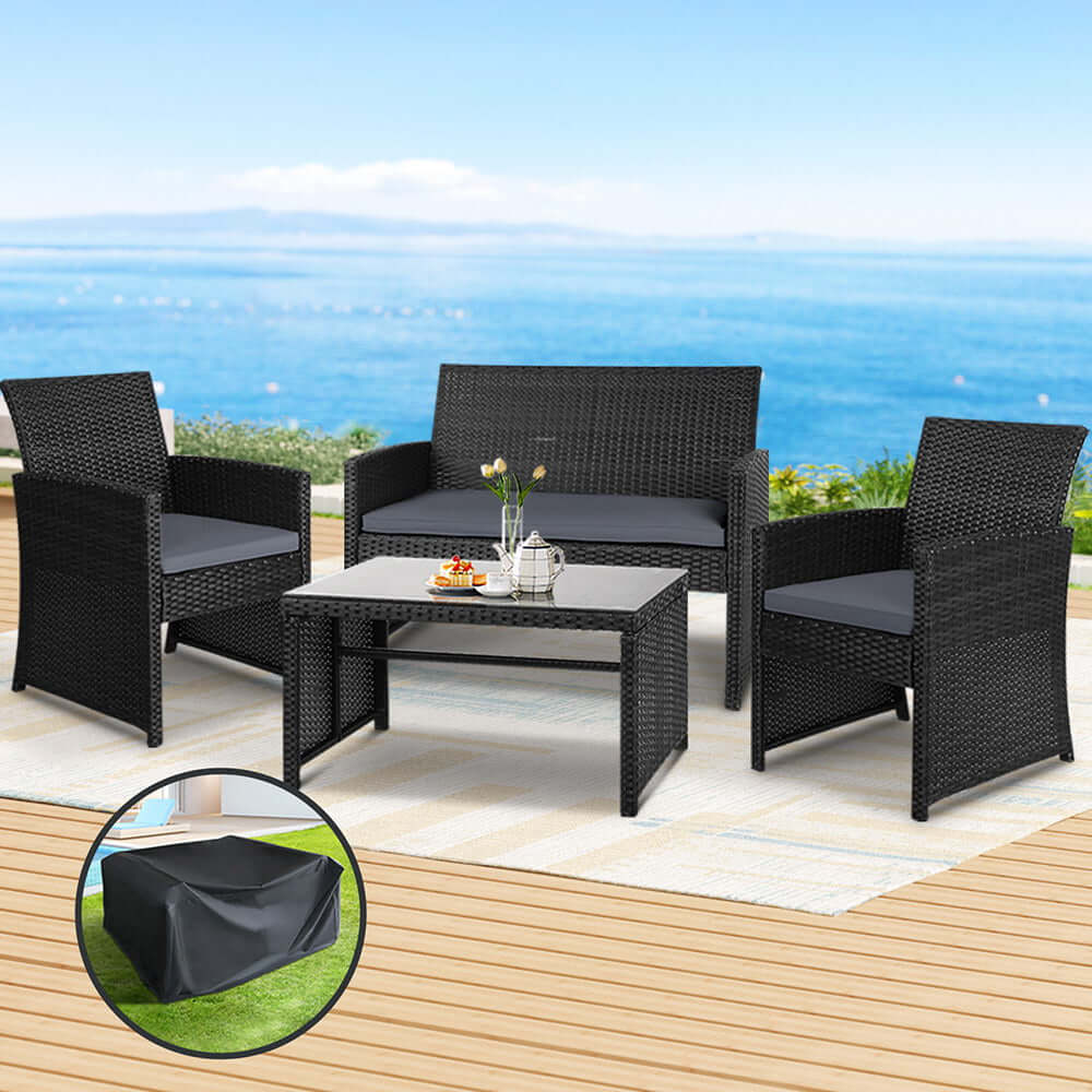 Gardeon 4 PCS Black Rattan Outdoor Sofa Set with Storage Cover on a patio overlooking the ocean.