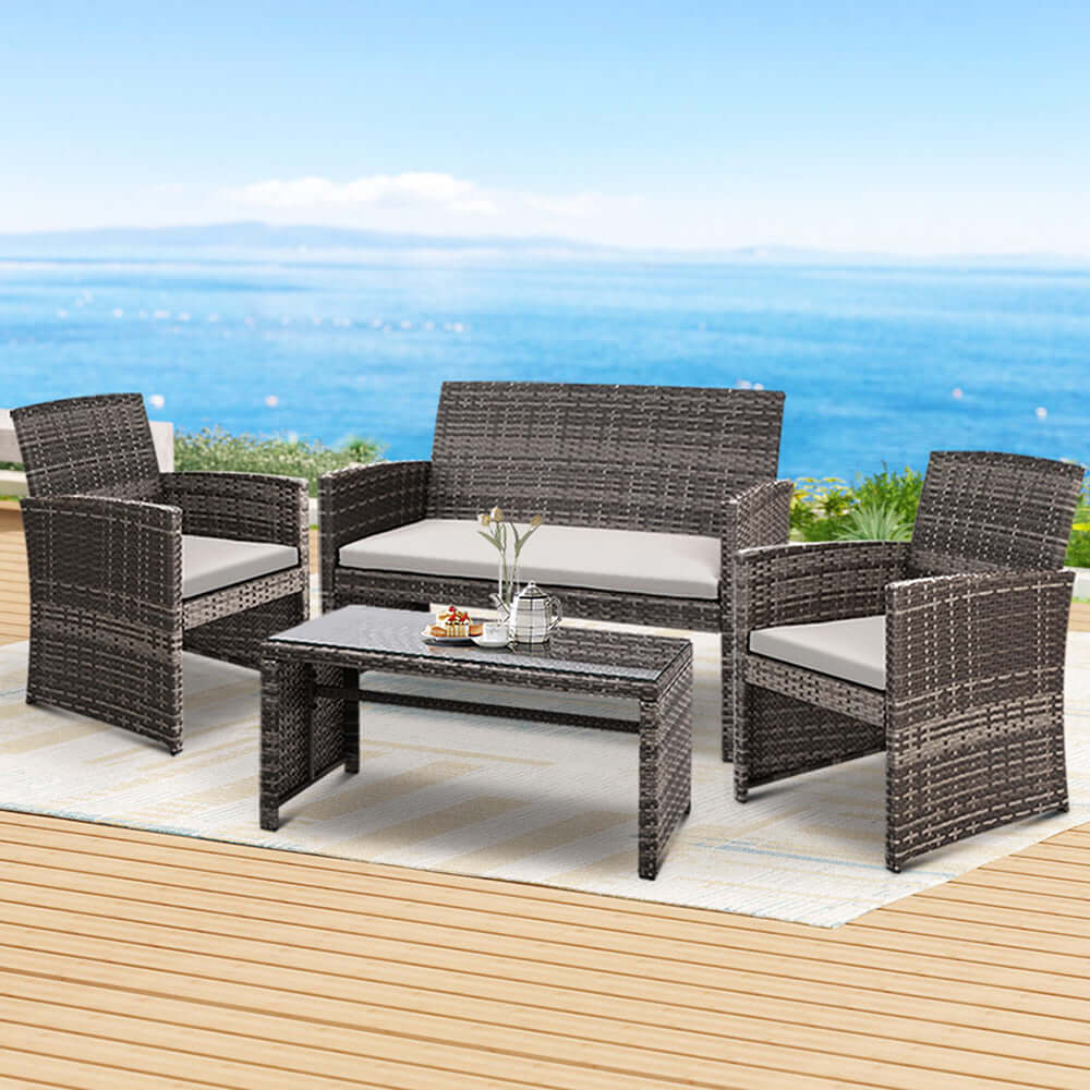 Gardeon 4 PCS outdoor rattan sofa set with table, perfect for garden decor and relaxation by the sea.