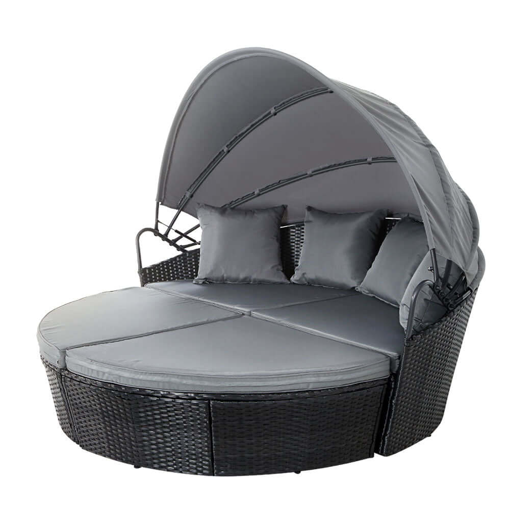 Gardeon black wicker sun lounge day bed with canopy and cushions for outdoor relaxation and summer enjoyment.