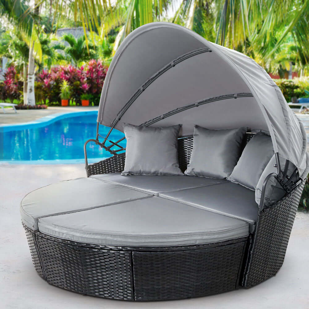 Gardeon outdoor wicker sun lounge day bed with canopy, perfect for affordable luxury patio relaxation by the pool.