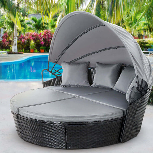 Gardeon outdoor wicker sun lounge day bed with canopy, perfect for affordable luxury patio relaxation by the pool.