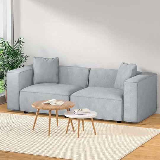 Artiss Modular Sofa Chaise Set 2-Seater Grey in modern living room with wooden coffee table and plants.