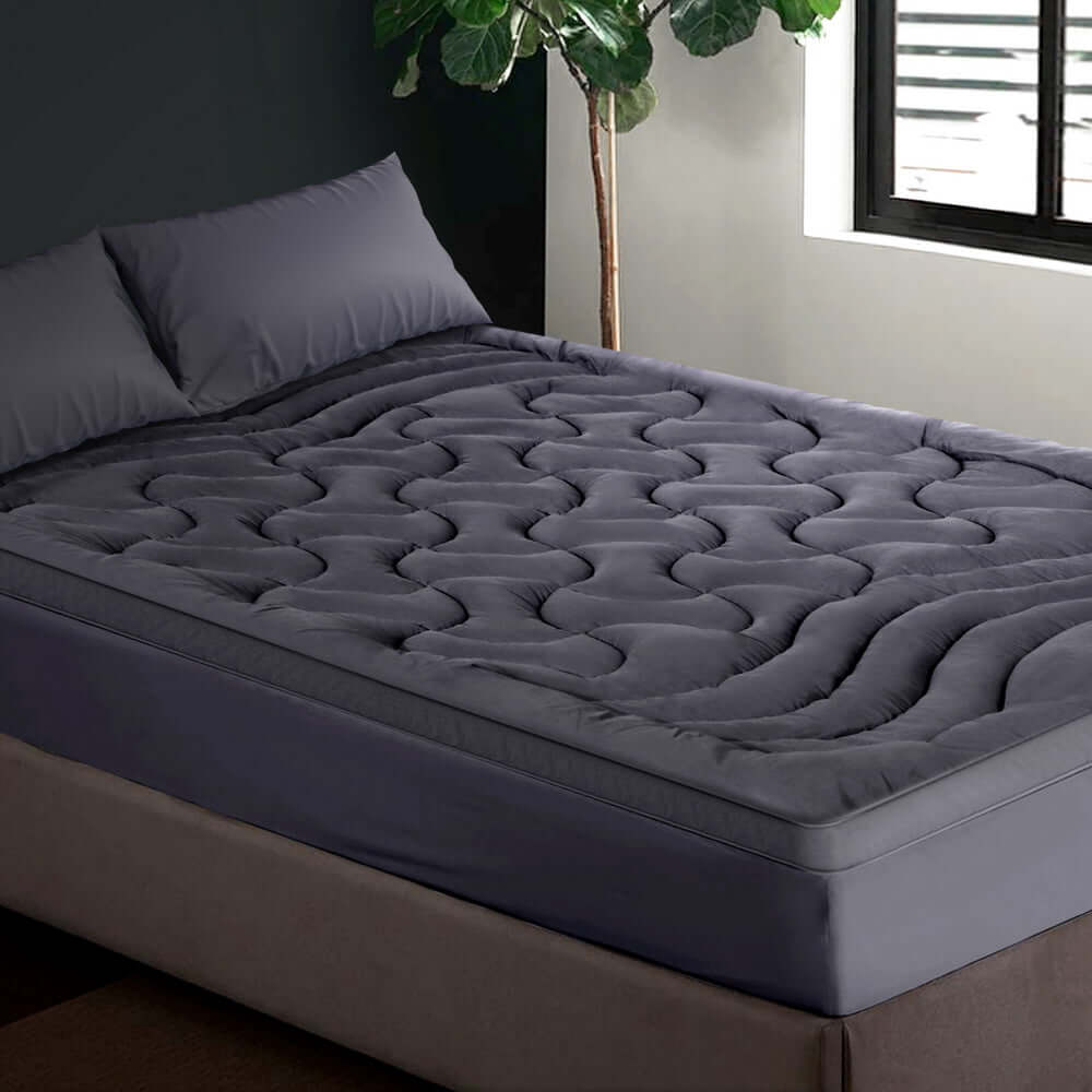 Giselle Bedding Pillowtop Mattress Topper on a bed, showcasing quality and comfort with a sleek, affordable design.