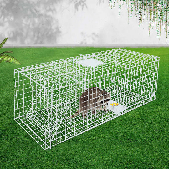 Gardeon Possum Trap Cage 150x50cm with raccoon inside on grass, humane and durable for safe animal capture.