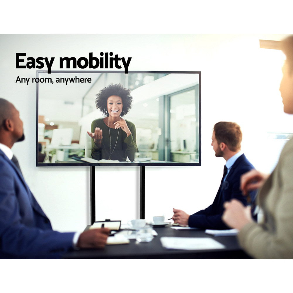 Mobile TV stand in a meeting room with a woman on screen, showcasing easy mobility for any environment.