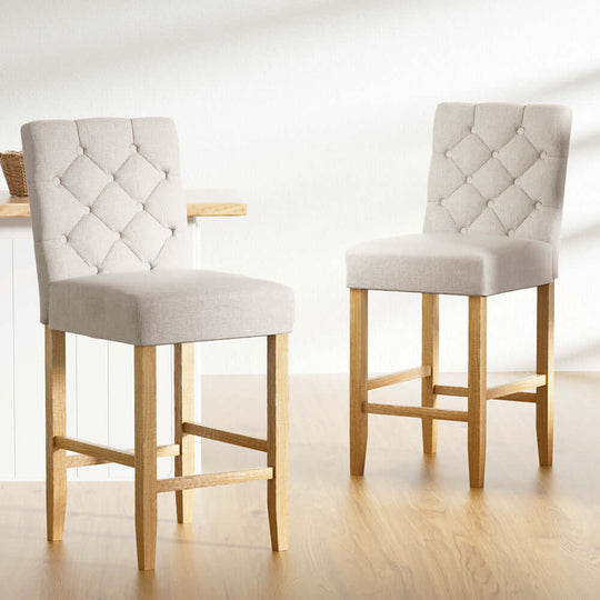 Elegant Artiss bar stools in soft linen upholstery with tufted buttons and wooden legs, perfect for affordable luxury decor.