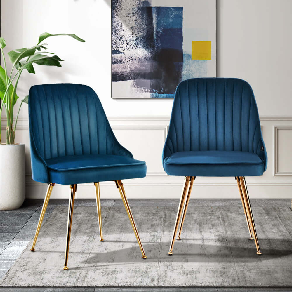 Artiss Dining Chairs Set of 2 Velvet Channel Tufted Blue with Gold Legs in a Modern Room