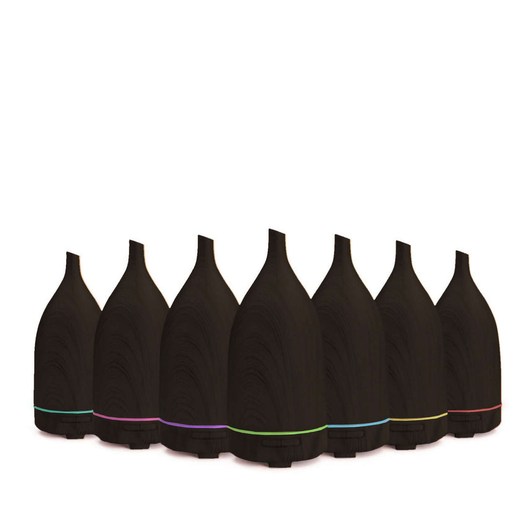 Milano Decor dark wood ultrasonic aroma diffusers lined up, showcasing quality design and vibrant LED lights.