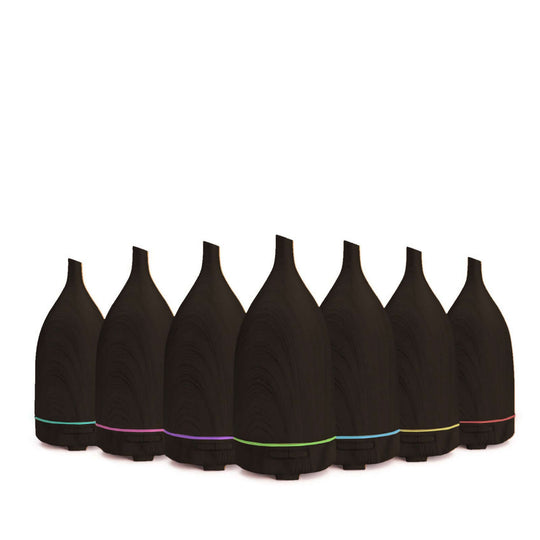 Milano Decor dark wood ultrasonic aroma diffusers lined up, showcasing quality design and vibrant LED lights.