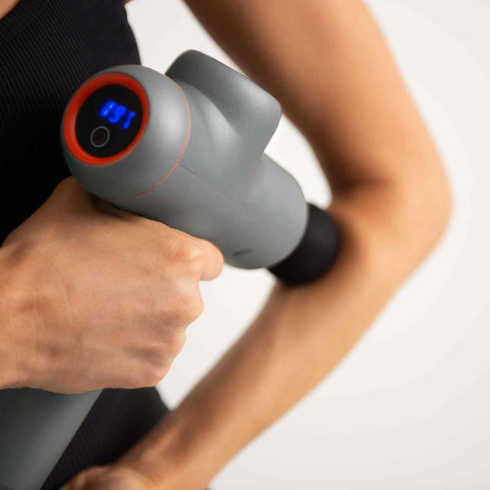 FitSmart LED Touch Screen POWER-X Massage Gun in grey, handheld, displaying settings, ideal for pain relief and muscle recovery.