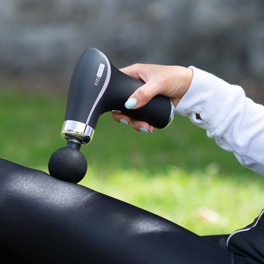 Affordable FitSmart Hyper Pro Mini FS-250 Vibration Massage Device in use, alleviating muscle tension outdoors.