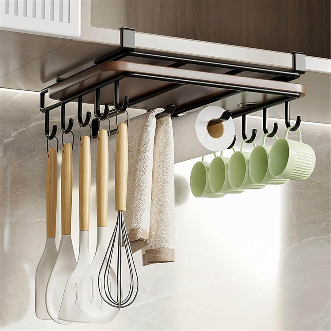 Multifunctional under cabinet cutting board holder and organiser with hooks for kitchen utensils and mugs.