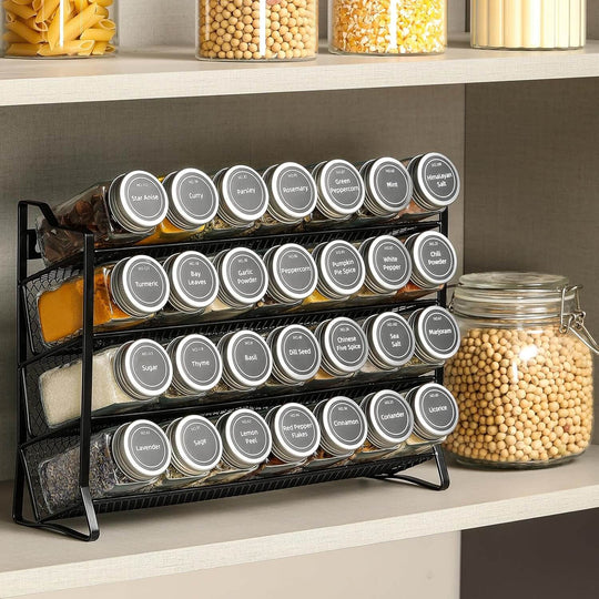 4-tier spice rack organizer with 28 glass jars and labels on kitchen shelf for efficient spice storage.