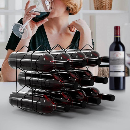 Stylish freestanding 14-bottle metal wine rack showcased with woman enjoying a glass of red wine in modern setting.