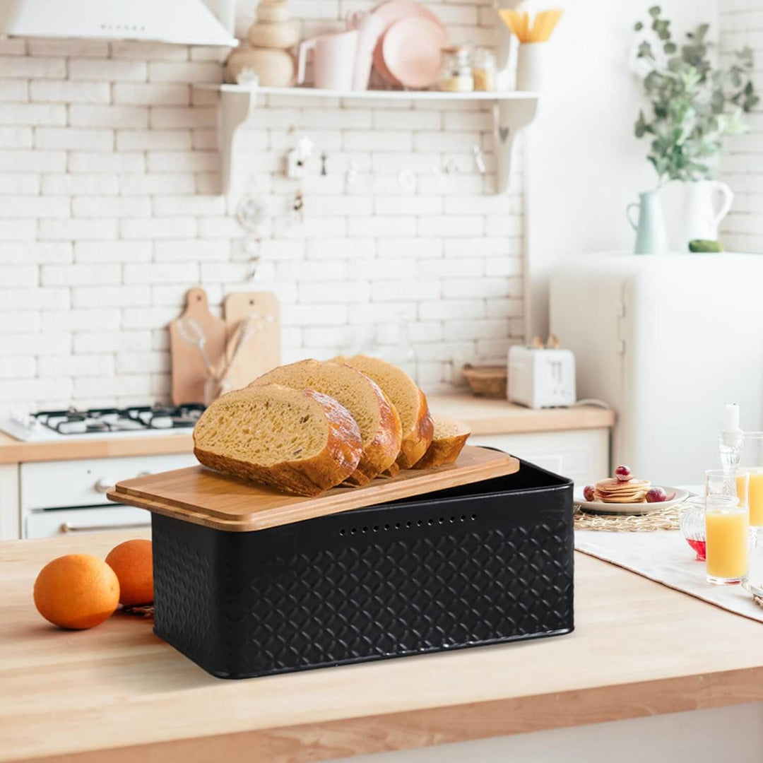 Stylish bread bin with bamboo lid serving as a chopping board on a kitchen countertop with sliced bread.