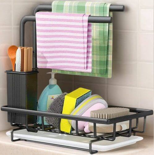 Sink caddy sponge holder with brush holder, dishcloths, and cleaning essentials for organized kitchen spaces.