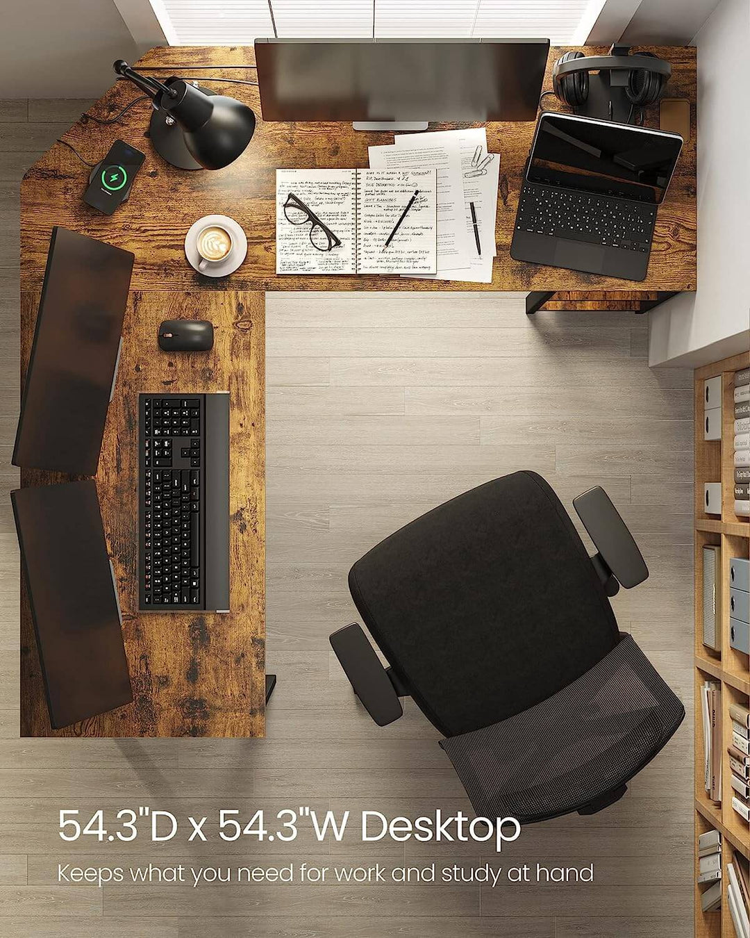 L-Shaped computer desk corner with 54.3"D x 54.3"W desktop, office chair, monitor, laptop, keyboard, mouse, lamp, and paperwork