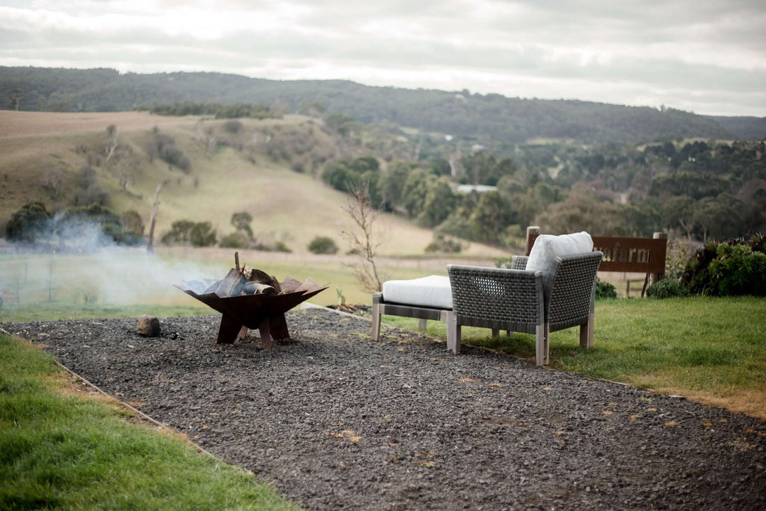 Affordable Paradise 3 piece setting by a bonfire with mountainous view, perfect for outdoor relaxation and comfort.