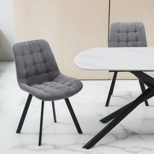 Modern dark grey fabric dining chair with sleek black legs, perfect for stylish interior decor and affordable luxury.