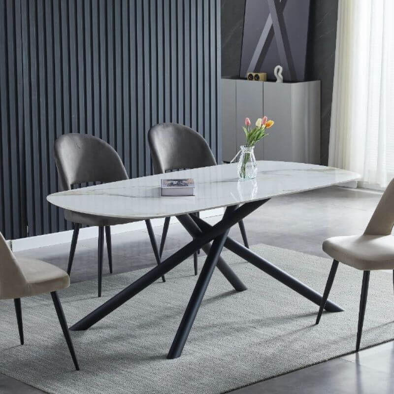 Affordable luxe dining table with marble stone top and sleek metal legs in modern interior setting.