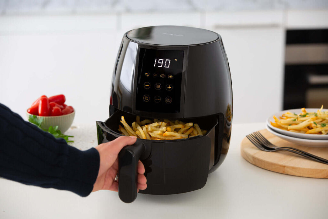 Person using 3L Digital Air Fryer with 200°C setting, featuring non-stick and removable basket, offering affordable quality from value furniture.