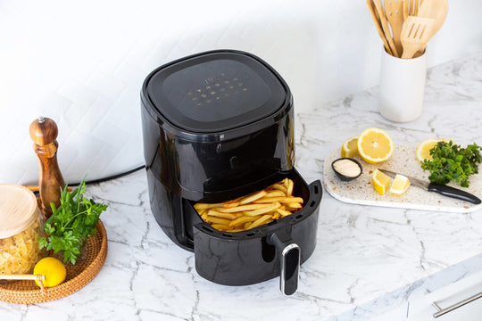 6L digital air fryer with glass window cooking fries, surrounded by fresh ingredients on a kitchen countertop, value furniture, affordable, quality