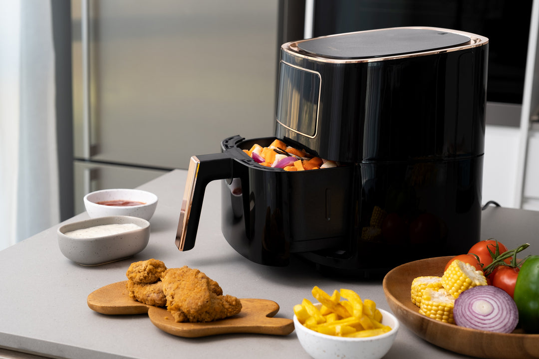 7L Digital Air Fryer (Black) cooking food on counter with bowls of vegetables and fried chicken, showcasing quality and affordable value furniture.