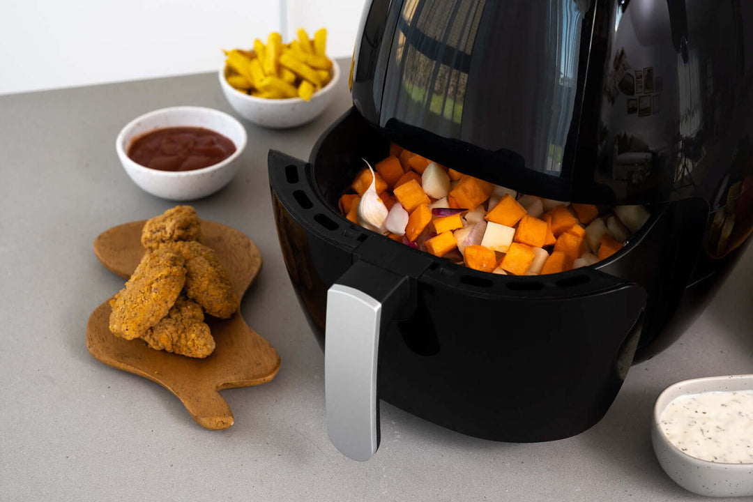 Cooking with 8L Digital Air Fryer, 1800W, Non-Stick, showcasing healthy food and crispy vegetables for a quality, affordable meal experience.